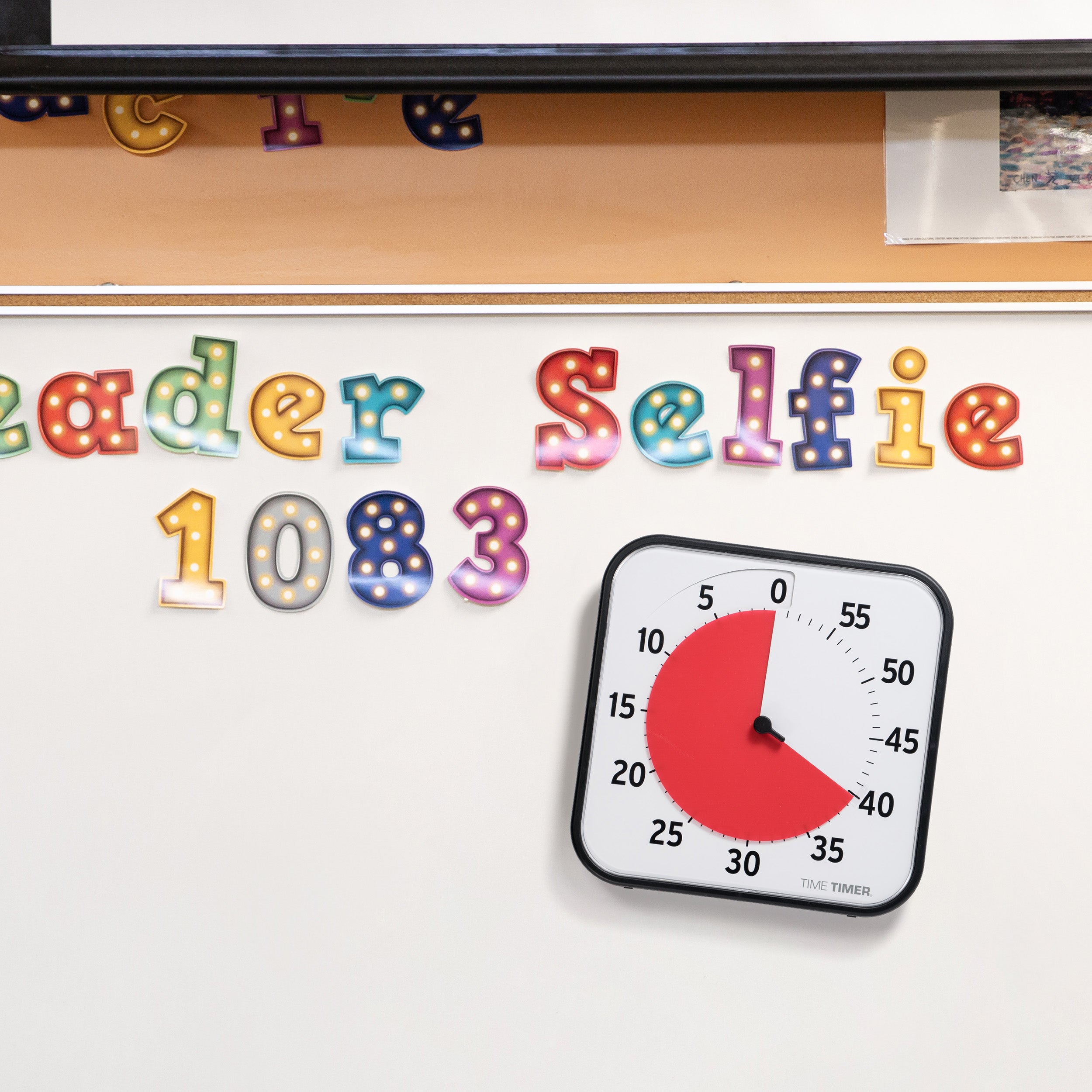 The Time Timer Original 12" has a magnetic back and is shown on a classroom whiteboard. 