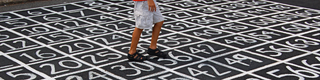 Man standing on numbers in square from 1-100